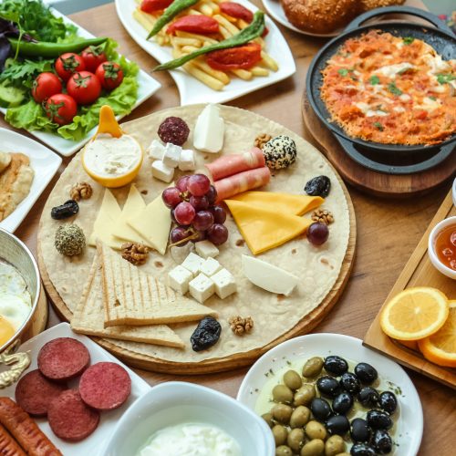 breakfast set cheese homey jam eggs olives toasts side view